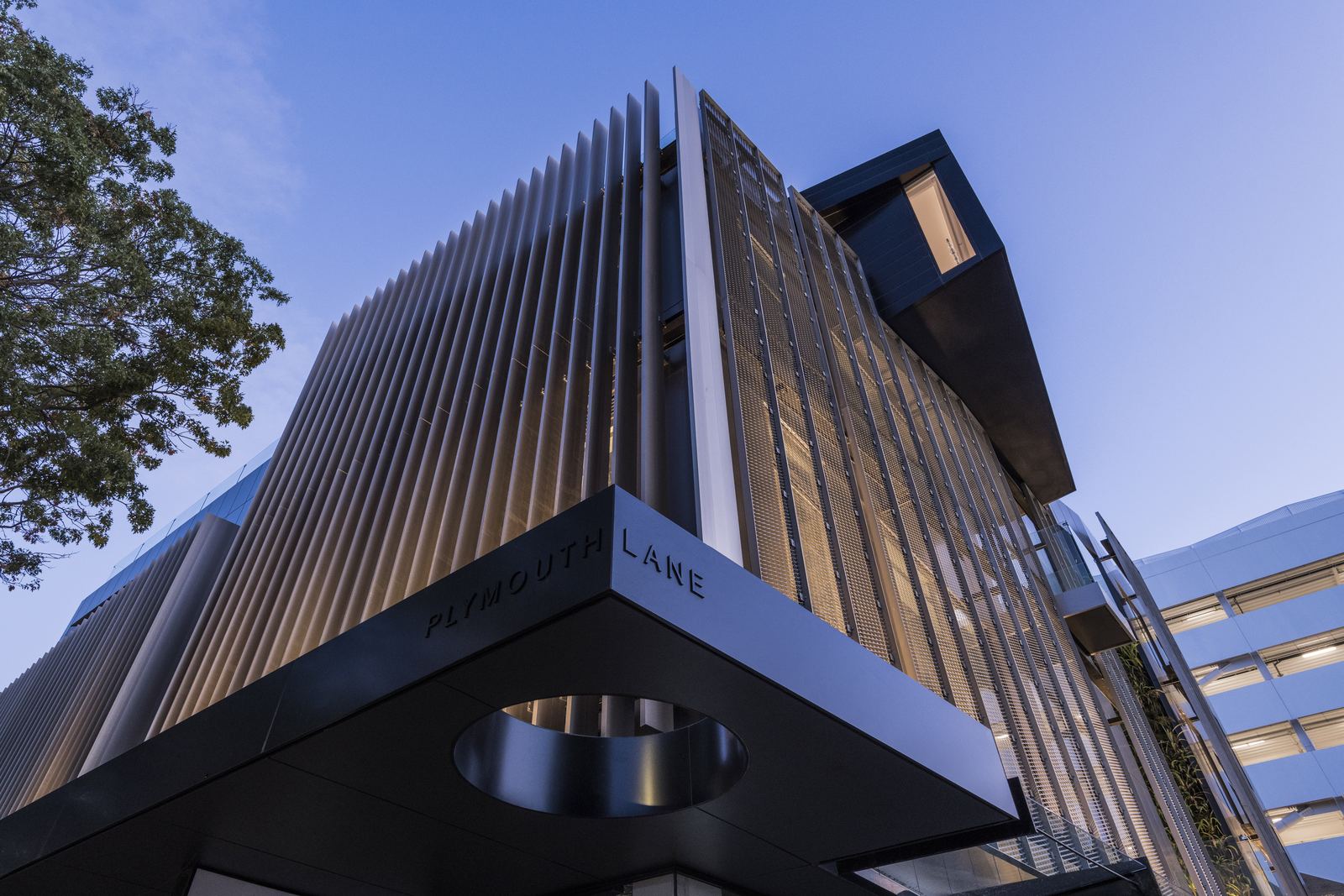 112 Cashel – Cashel Mall mixed-use building with bronze fins by AW Architects