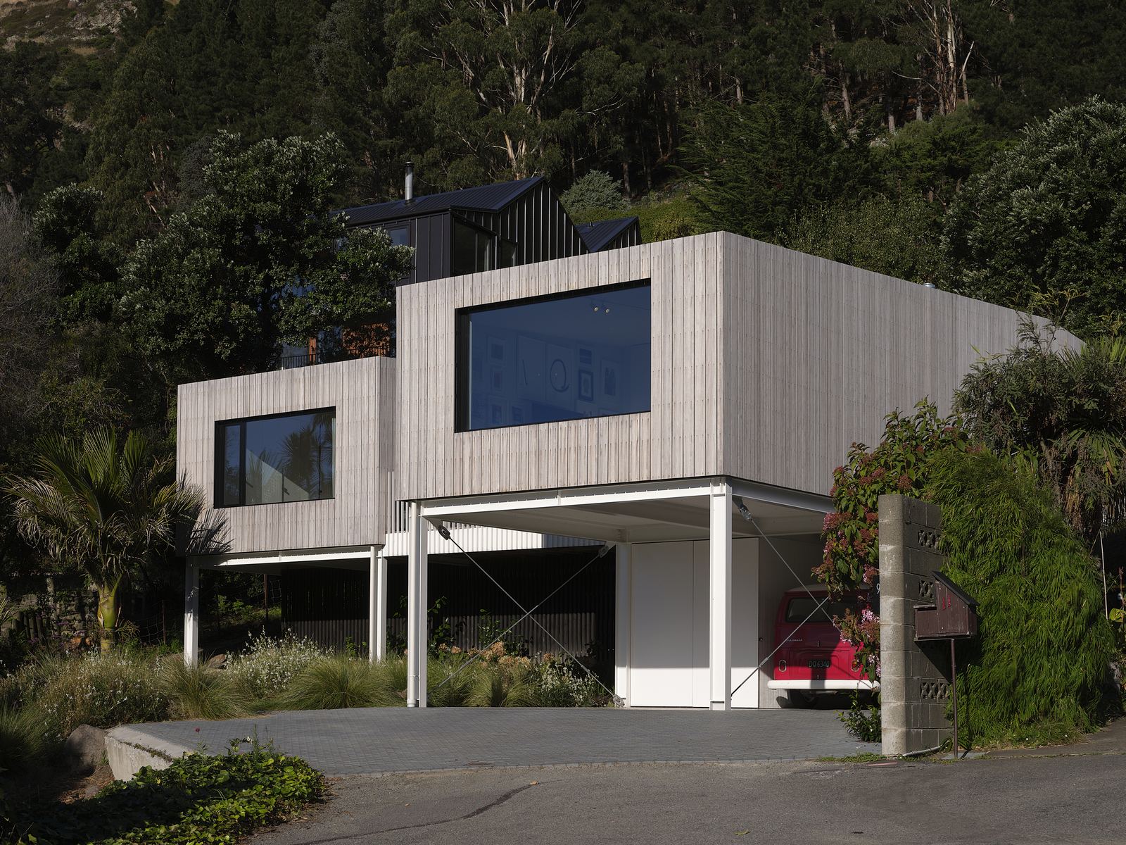 Ocean View Terrace House, Sumner – prefabricated family home with oak interiors and valley views by AW Architects